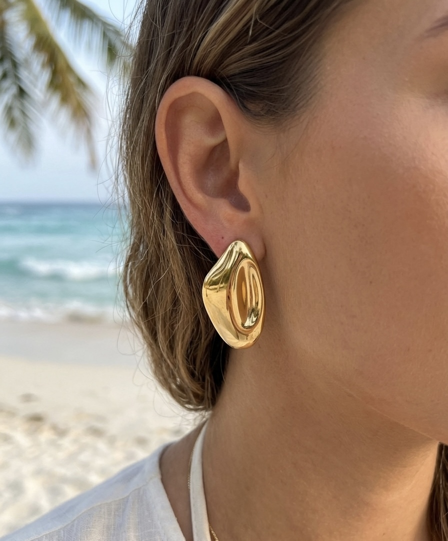 Gold earring by the sea