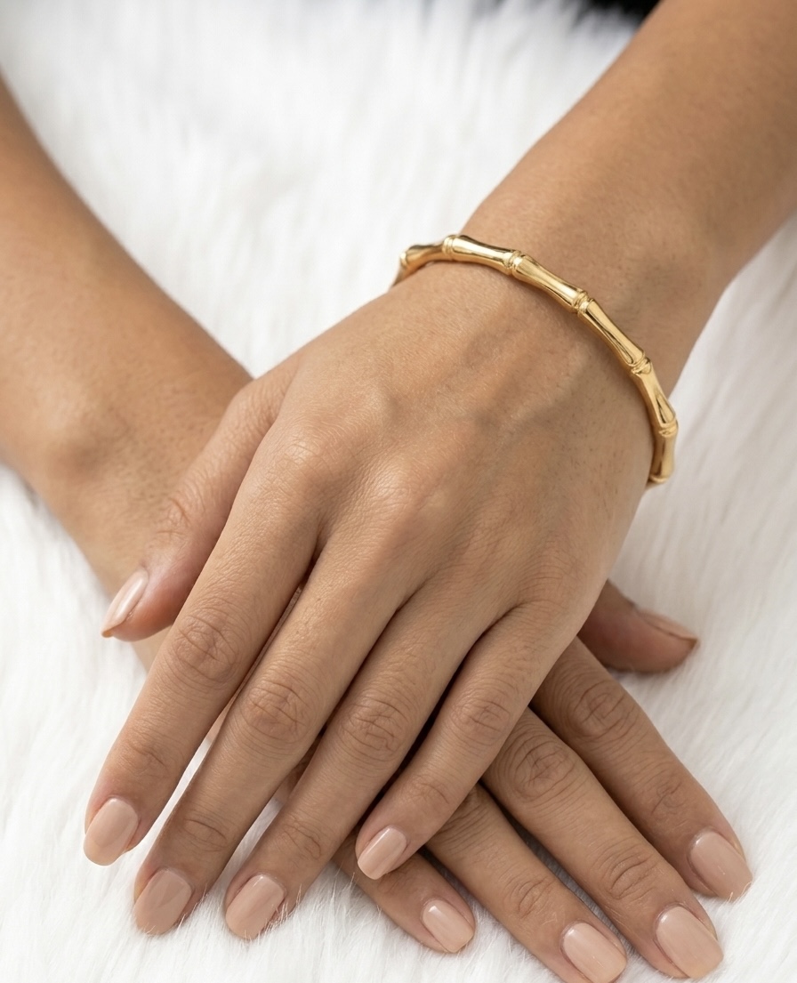 Gold bangle on hand